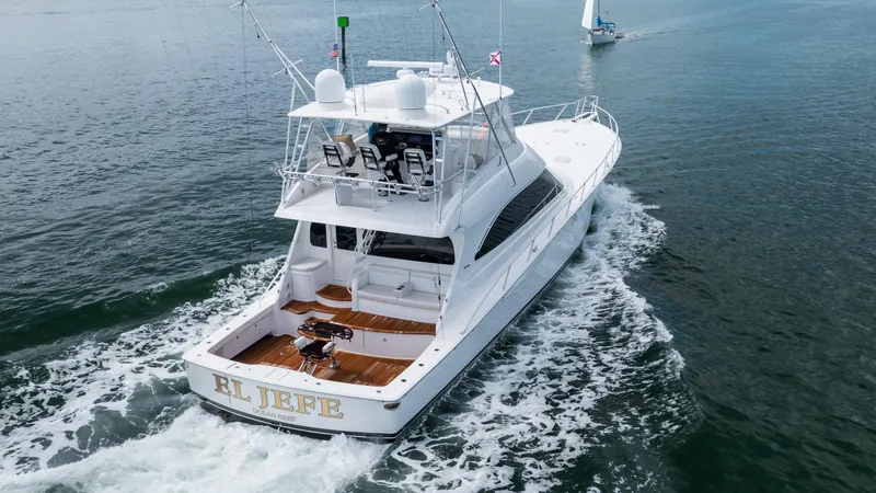 "el Jefe" Yacht Photos Pics 2014 Viking 70 Convertible yacht cruising on open water, rear view.