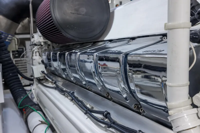"el Jefe" Yacht Photos Pics Engine compartment of a 2014 Viking 70 Convertible yacht, showcasing polished metal components.