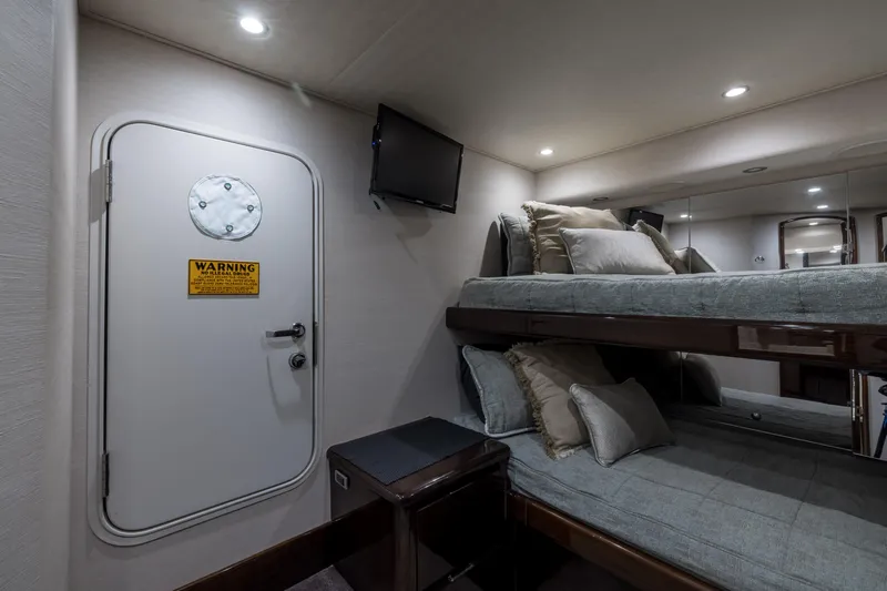 "el Jefe" Yacht Photos Pics Interior of 2014 Viking 70 Convertible yacht with bunk beds and a wall-mounted TV.