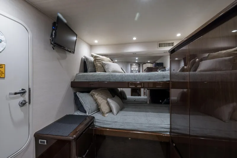 "el Jefe" Yacht Photos Pics Luxurious cabin interior of 2014 Viking 70 Convertible yacht with bunk beds and TV.