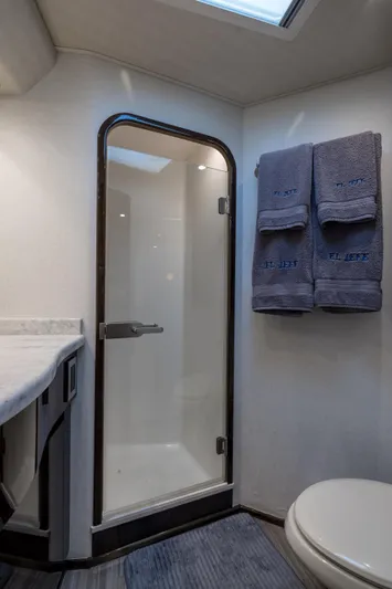 "el Jefe" Yacht Photos Pics 2014 Viking 70 Convertible yacht bathroom with shower, towels, and modern fixtures.