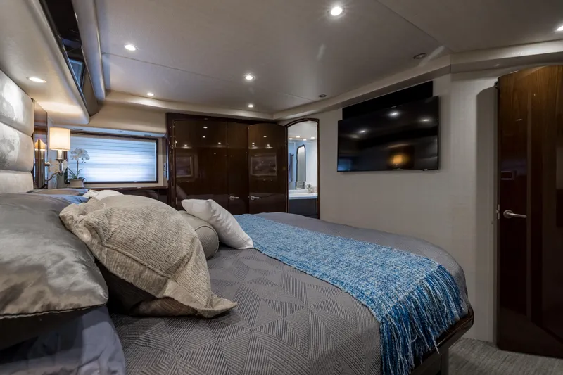 "el Jefe" Yacht Photos Pics Luxurious bedroom interior of 2014 Viking 70 Convertible yacht with modern decor.