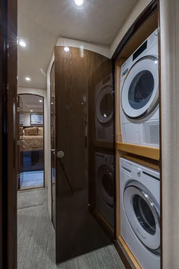 "el Jefe" Yacht Photos Pics Laundry area inside 2014 Viking 70 Convertible yacht with stacked washer and dryer.