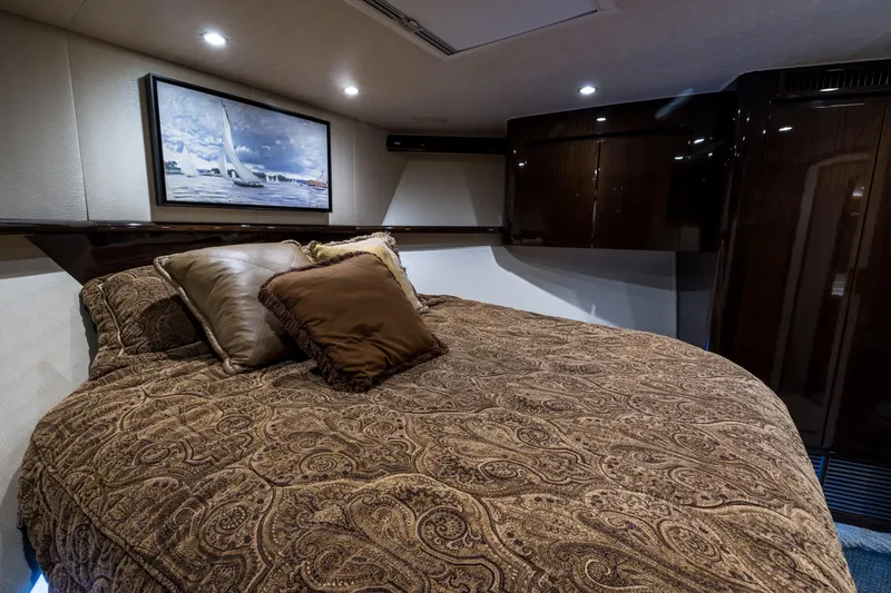 "el Jefe" Yacht Photos Pics Luxurious bedroom interior of 2014 Viking 70 Convertible yacht with elegant bedding and artwork.