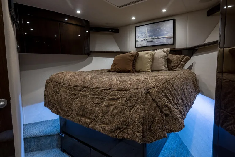 "el Jefe" Yacht Photos Pics Luxurious bedroom interior of 2014 Viking 70 Convertible yacht with elegant bedding and ambient lighting.
