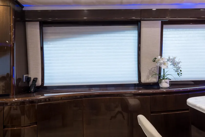 "el Jefe" Yacht Photos Pics Interior of 2014 Viking 70 Convertible yacht with elegant wood finish and window blinds.
