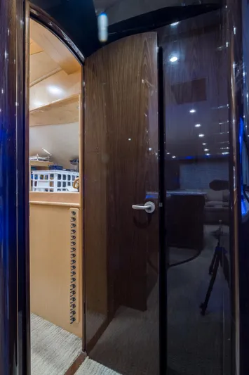 "el Jefe" Yacht Photos Pics Interior view of 2014 Viking 70 Convertible yacht with wooden door and modern lighting.