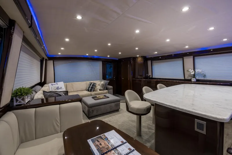 "el Jefe" Yacht Photos Pics Luxurious interior of a 2014 Viking 70 Convertible yacht with elegant seating and ambient lighting.