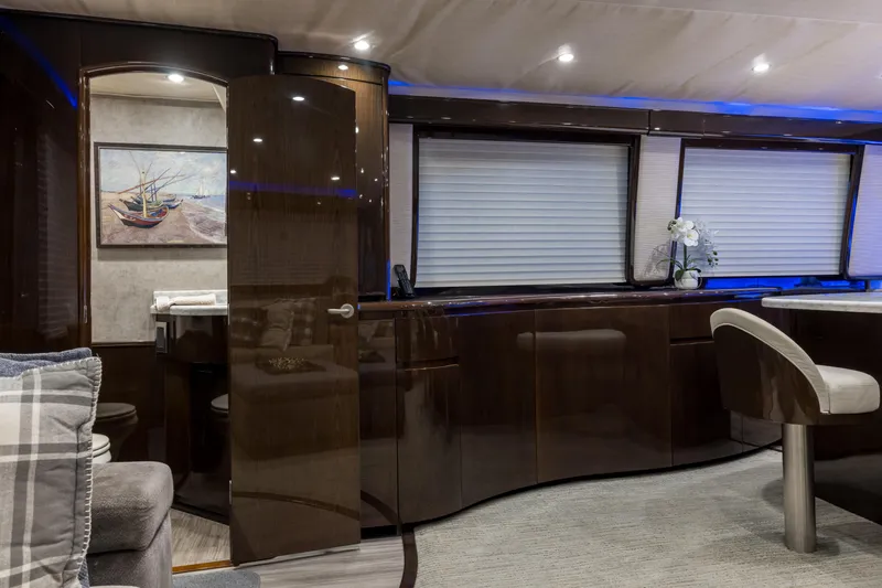 "el Jefe" Yacht Photos Pics Luxurious interior of a 2014 Viking 70 Convertible yacht with elegant wood finishes.