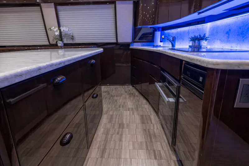 "el Jefe" Yacht Photos Pics Luxurious kitchen interior of 2014 Viking 70 Convertible yacht with modern design and ambient lighting.