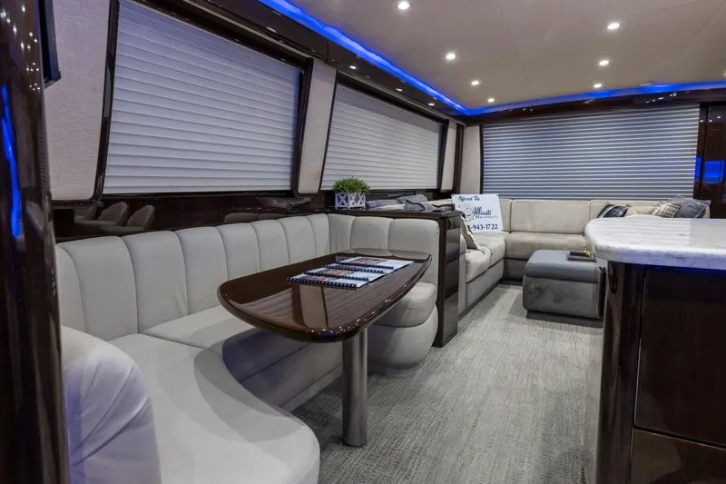 "el Jefe" Yacht Photos Pics Luxurious interior of a 2014 Viking 70 Convertible yacht with elegant seating and ambient lighting.
