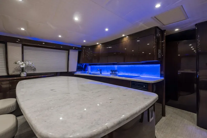 "el Jefe" Yacht Photos Pics Luxurious interior of 2014 Viking 70 Convertible yacht with modern kitchen and ambient lighting.