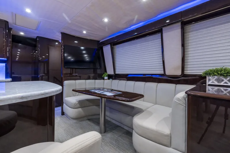 "el Jefe" Yacht Photos Pics Luxurious interior of a 2014 Viking 70 Convertible yacht with elegant seating and modern decor.