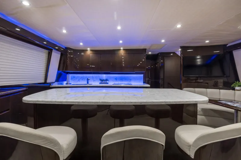 "el Jefe" Yacht Photos Pics Luxurious interior of 2014 Viking 70 Convertible yacht with modern kitchen and seating area.