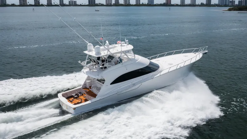 "el Jefe" Yacht Photos Pics 2014 Viking 70 Convertible yacht cruising on open water, creating a dynamic wake.