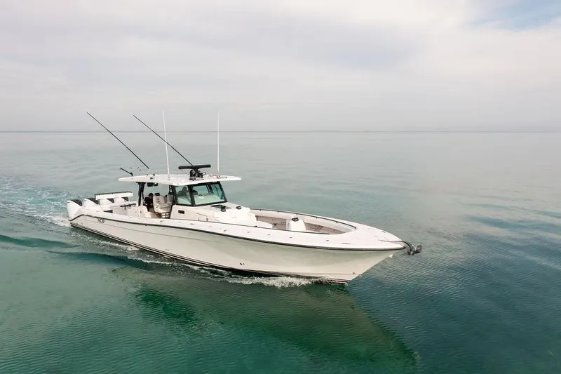  Yacht Photos Pics 2019 HCB 53 boat cruising on calm, clear waters under a cloudy sky.