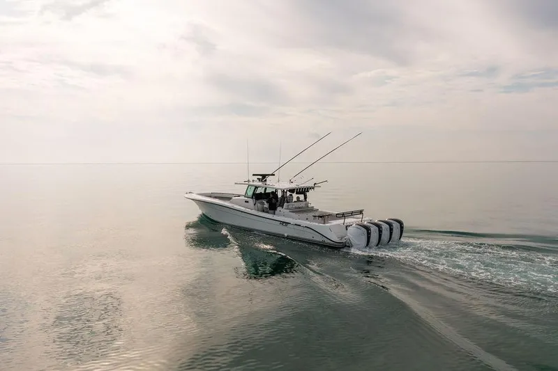  Yacht Photos Pics 2019 HCB 53 boat cruising on calm water under a cloudy sky.