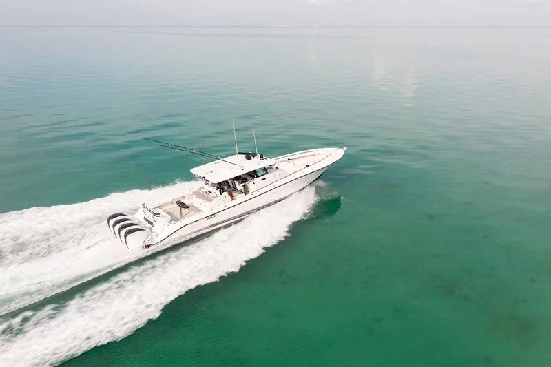  Yacht Photos Pics Aerial view of 2019 HCB 53 boat cruising on clear turquoise water.