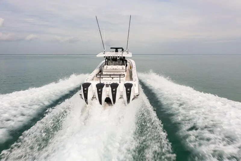  Yacht Photos Pics 2019 HCB 53 boat speeding on open water, leaving a wake behind.