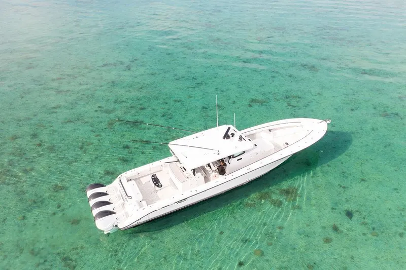  Yacht Photos Pics Aerial view of 2019 HCB 53 boat on clear turquoise water.