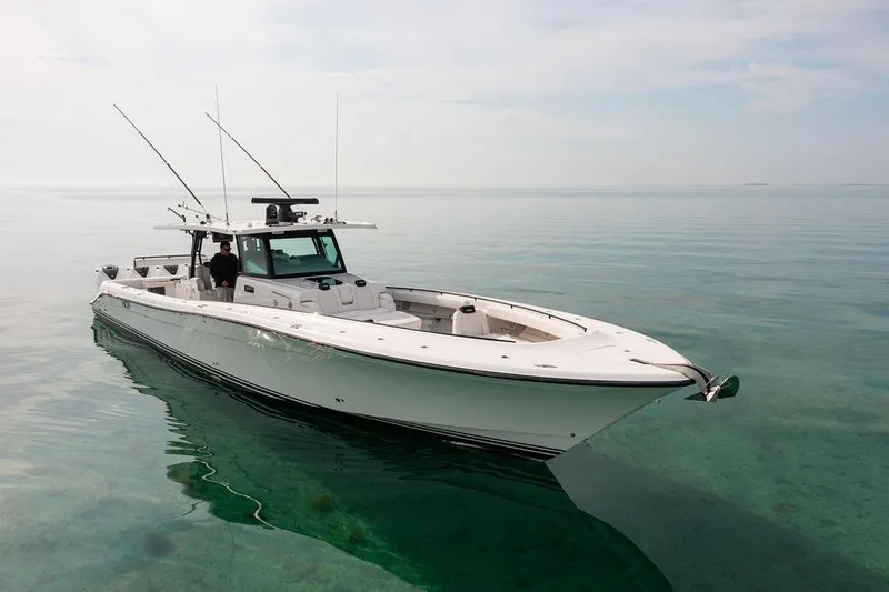 Yacht Photos Pics 2019 HCB 53 boat on calm, clear water with fishing rods and equipment.