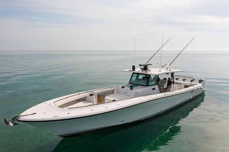  Yacht Photos Pics 2019 HCB 53 boat on calm water, featuring sleek design and fishing rods.