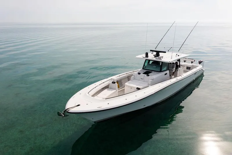  Yacht Photos Pics 2019 HCB 53 boat on calm, clear water with fishing rods.