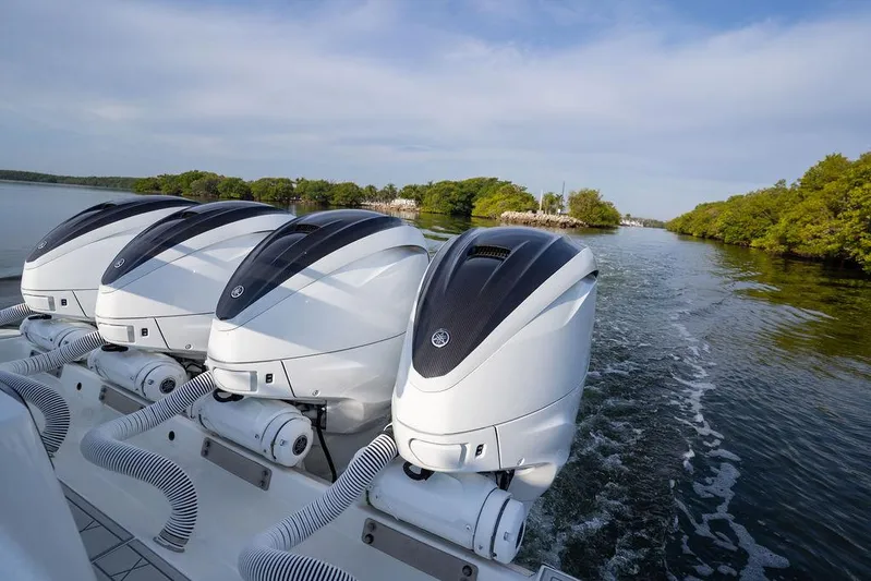  Yacht Photos Pics Four powerful outboard engines on a 2019 HCB 53 boat cruising through scenic waters.