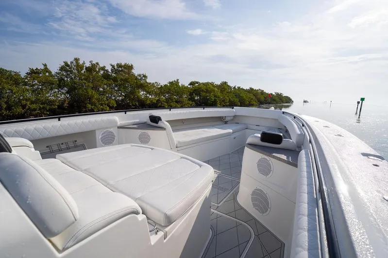  Yacht Photos Pics Luxurious 2019 HCB 53 boat interior with white seating, set against a serene water backdrop.