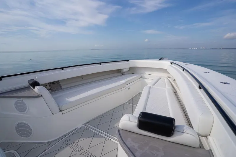  Yacht Photos Pics 2019 HCB 53 boat interior with white seating, calm ocean backdrop.