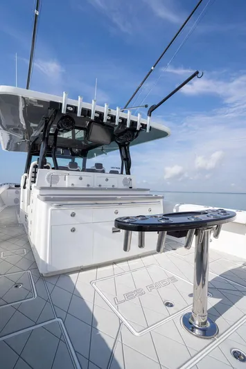  Yacht Photos Pics 2019 HCB 53 boat deck with fishing rods and equipment under a clear blue sky.