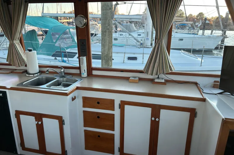  Yacht Photos Pics Interior of 1991 Holland 38 boat with kitchen sink, cabinets, and marina view.