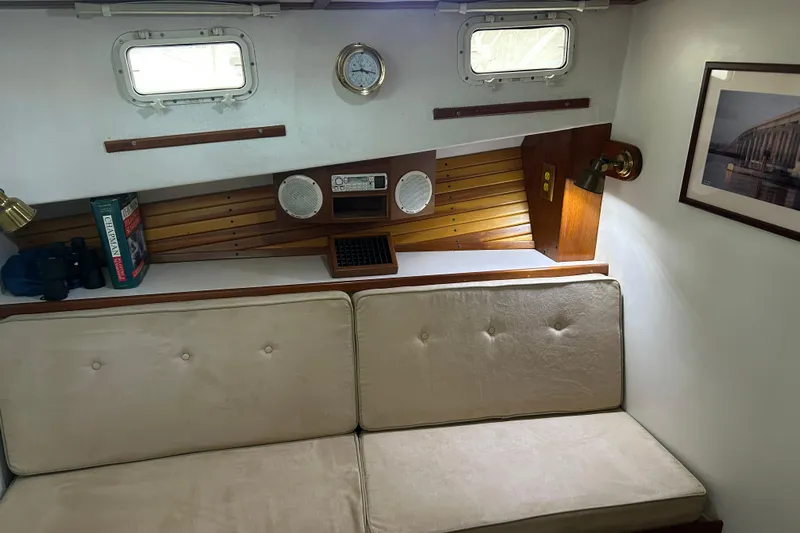  Yacht Photos Pics Interior of a 1991 Holland 38 boat with beige seating and nautical decor.