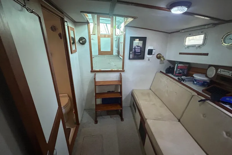  Yacht Photos Pics Interior of 1991 Holland 38 boat with seating, storage, and nautical decor.