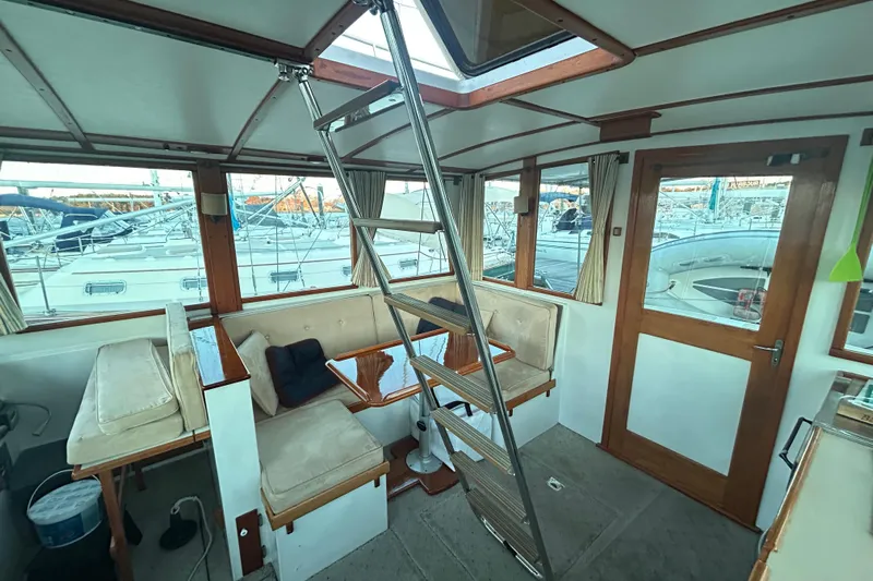  Yacht Photos Pics Interior of 1991 Holland 38 boat with seating, ladder, and marina view.