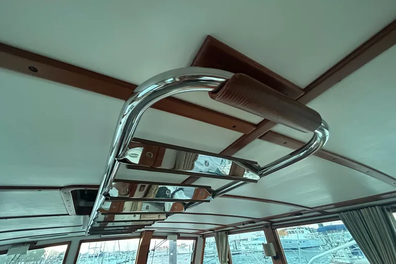  Yacht Photos Pics Interior view of a 1991 Holland 38 boat with a polished metal handrail.