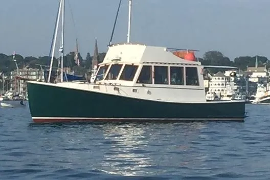  Yacht Photos Pics 1991 Holland 38 boat on calm water near a marina.