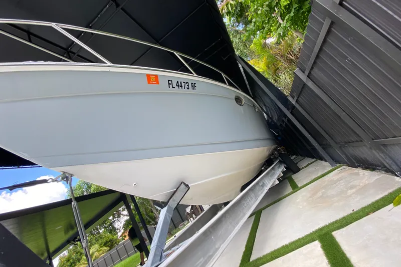  Yacht Photos Pics 2005 Formula 330 Sun Sport boat on trailer, parked under a canopy.