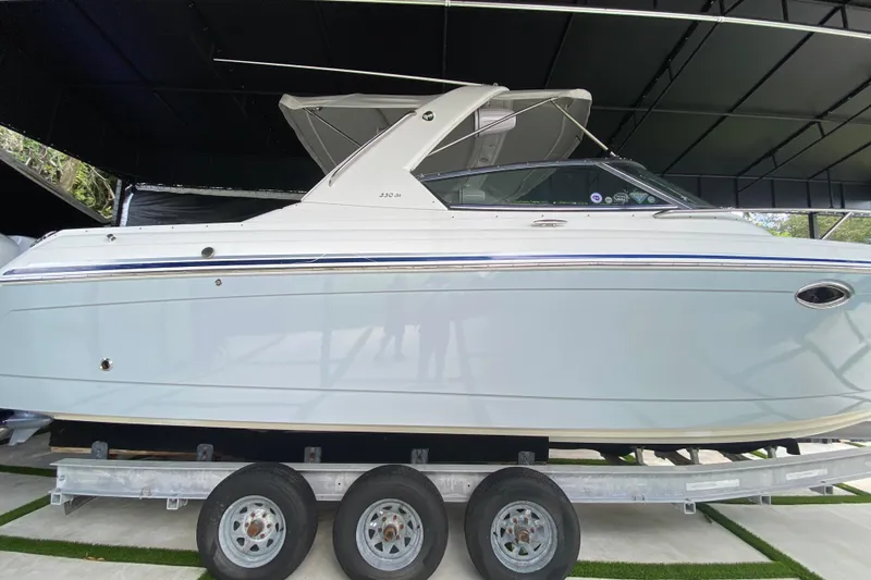  Yacht Photos Pics 2005 Formula 330 Sun Sport boat on a trailer in a covered area.