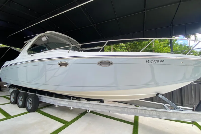  Yacht Photos Pics 2005 Formula 330 Sun Sport boat on trailer, under a canopy.