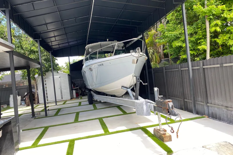  Yacht Photos Pics 2005 Formula 330 Sun Sport boat on trailer under a covered storage area.