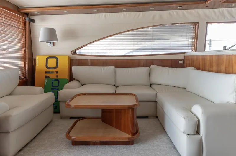  Yacht Photos Pics Luxurious interior of a 2004 Bertram 630 yacht with plush seating and wooden accents.