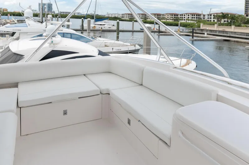  Yacht Photos Pics Luxurious seating area on a 2004 Bertram 630 yacht docked at a marina.