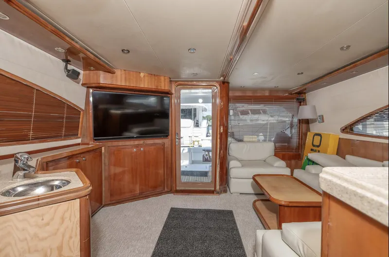  Yacht Photos Pics Luxurious interior of 2004 Bertram 630 yacht with modern furnishings and entertainment system.