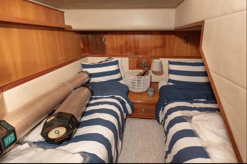  Yacht Photos Pics Cozy twin cabin with striped bedding in 2004 Bertram 630 yacht.