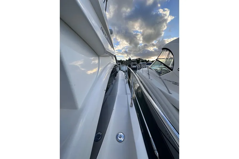 3 Princess Yacht Photos Pics 2011 Azimut 38 yacht docked under a cloudy sky, showcasing sleek design.