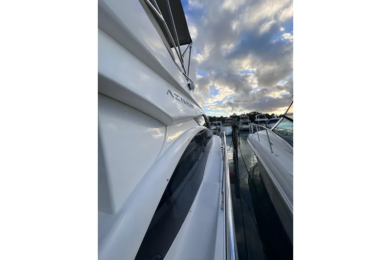 3 Princess Yacht Photos Pics 2011 Azimut 38 yacht docked at sunset with cloudy sky.