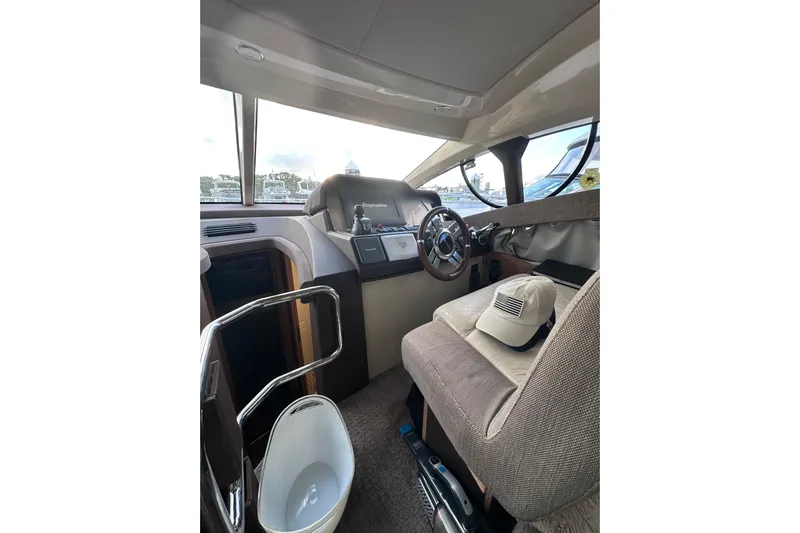 3 Princess Yacht Photos Pics Interior of 2011 Azimut 38 yacht cockpit with steering wheel and navigation equipment.