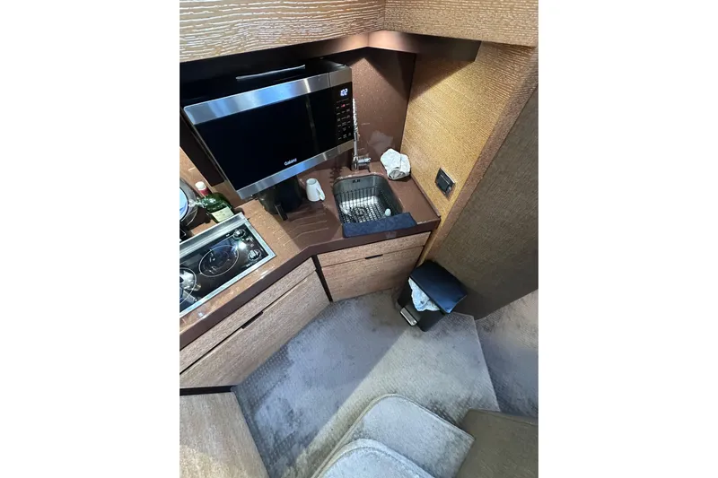 3 Princess Yacht Photos Pics Compact kitchen area in a 2011 Azimut 38 yacht with microwave and sink.