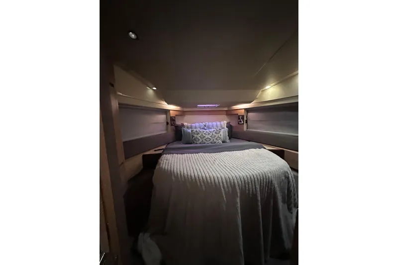 3 Princess Yacht Photos Pics Luxurious bedroom interior of 2011 Azimut 38 yacht with cozy bedding and ambient lighting.